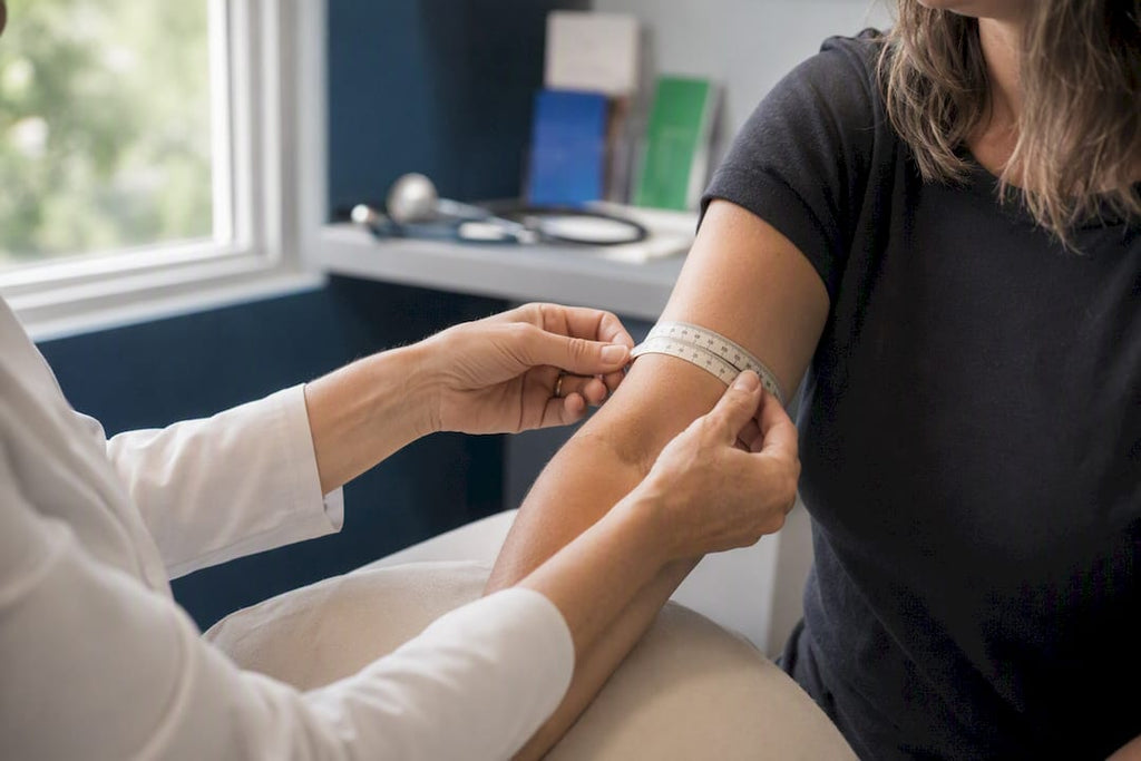 Measuring arm circumference with tape measure