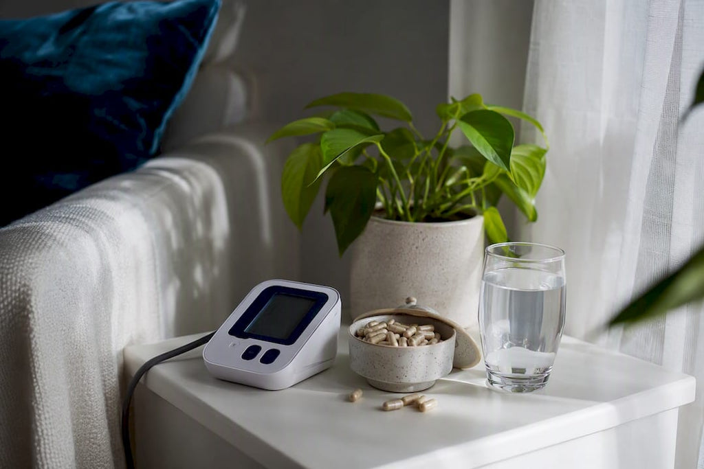 Magnesium capsules next to blood pressure monitor