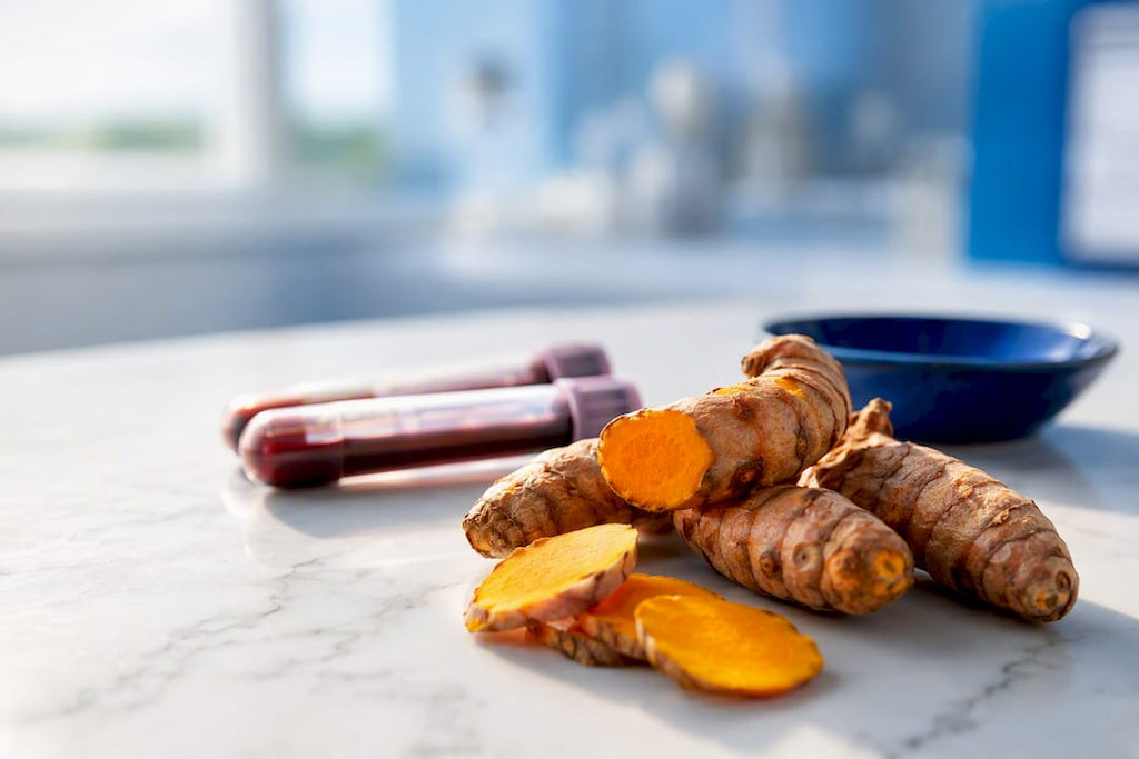 Turmeric root beside anonymous liver test samples