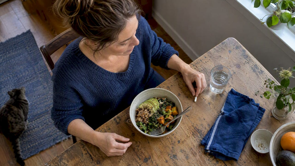 Probiotic capsule beside a meal